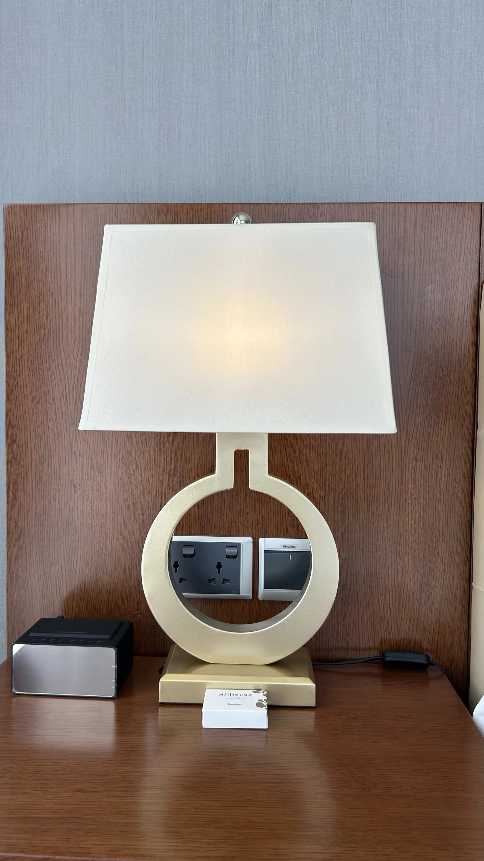 A bedside lamp shade in a hotel room, built by KAHA