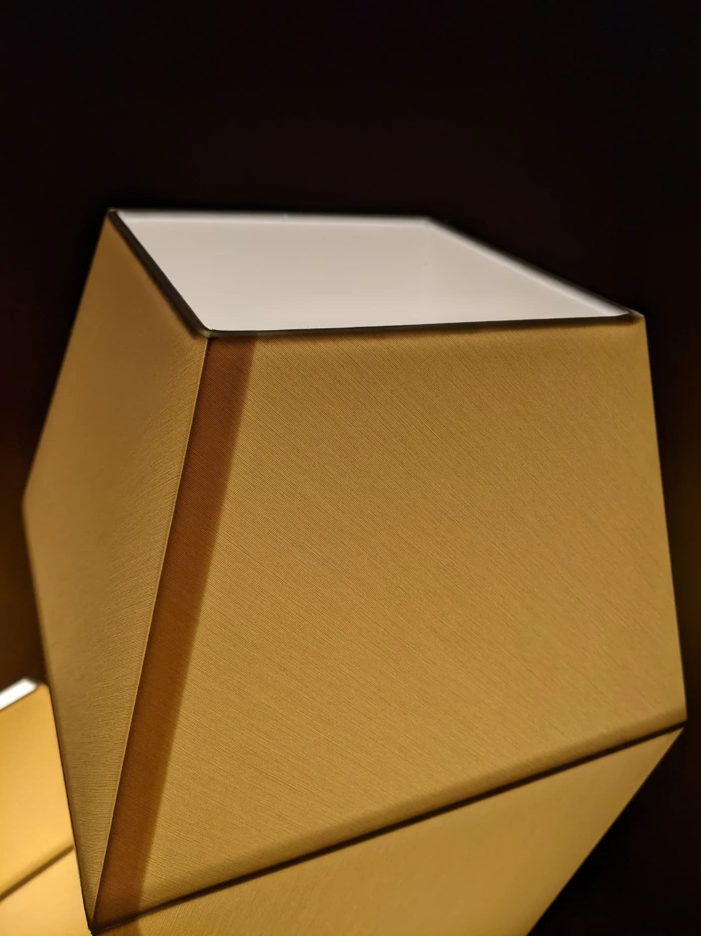 A square-shaped fabric shade in a dark gold tone, built by KAHA