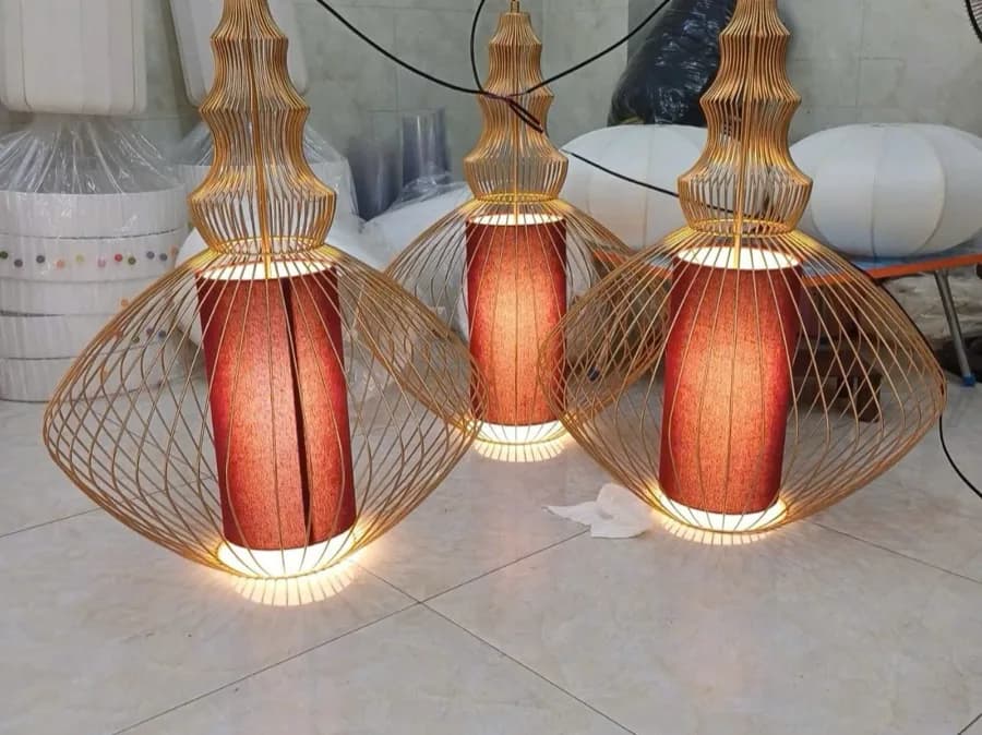 A gold cylinder-shaped decorative fabric lamp built to order at KAHA's workshop, the kind of piece a property refresh might include