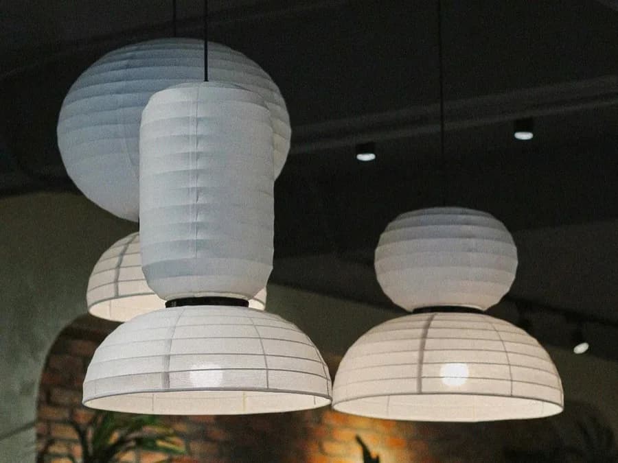 A cluster of premium linen fabric lamps showing the texture and drape of the material
