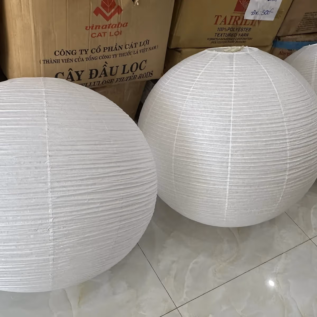 Two finished wabi-sabi fabric lamps sitting side by side, ready for packing at KAHA